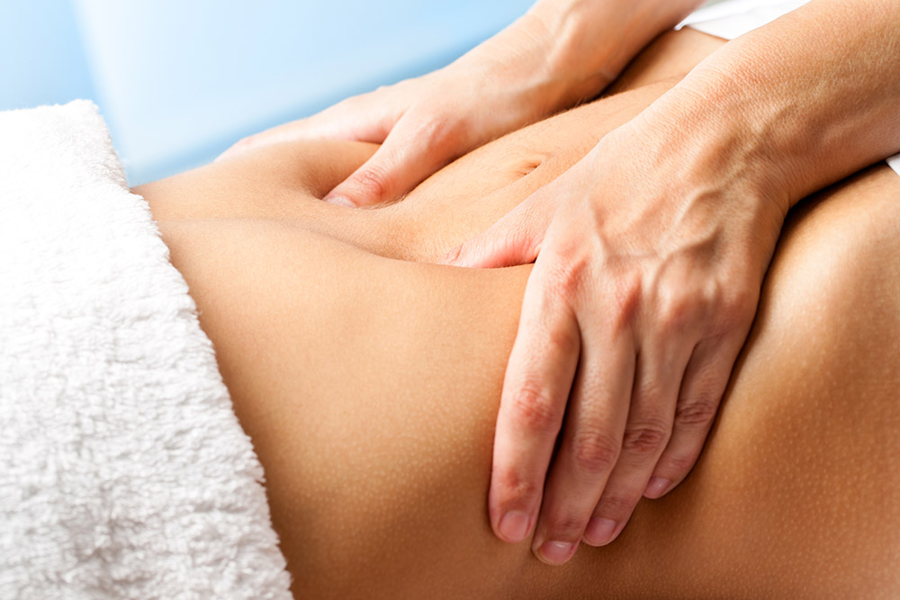 Female Patient at the physiotherapy doing physical exercises with her therapist, he gives her a medical massage